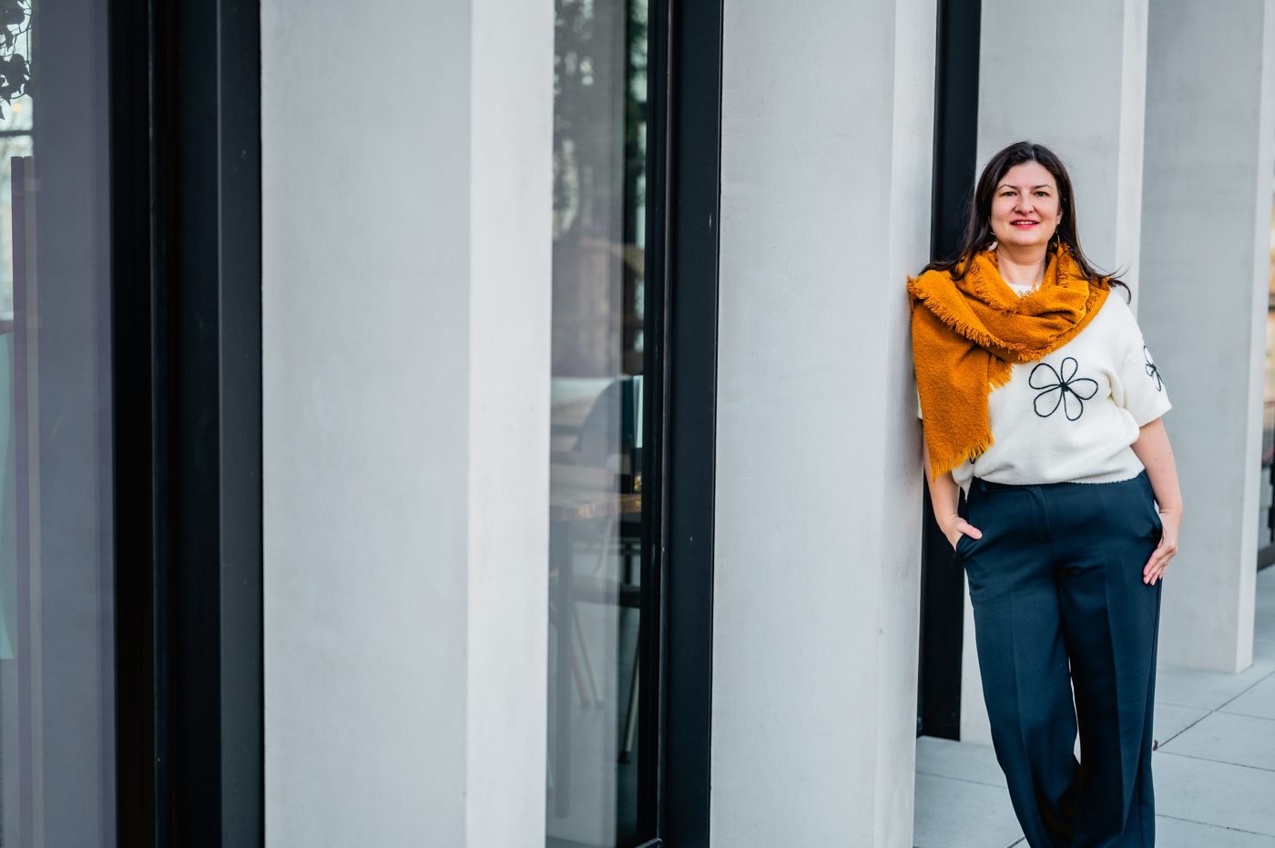 Muriel leaning against a building