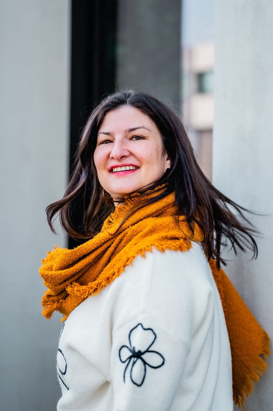 Muriel Maebe smiling, wearing an orange scarf